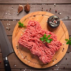 Minced meat on rustic wooden background